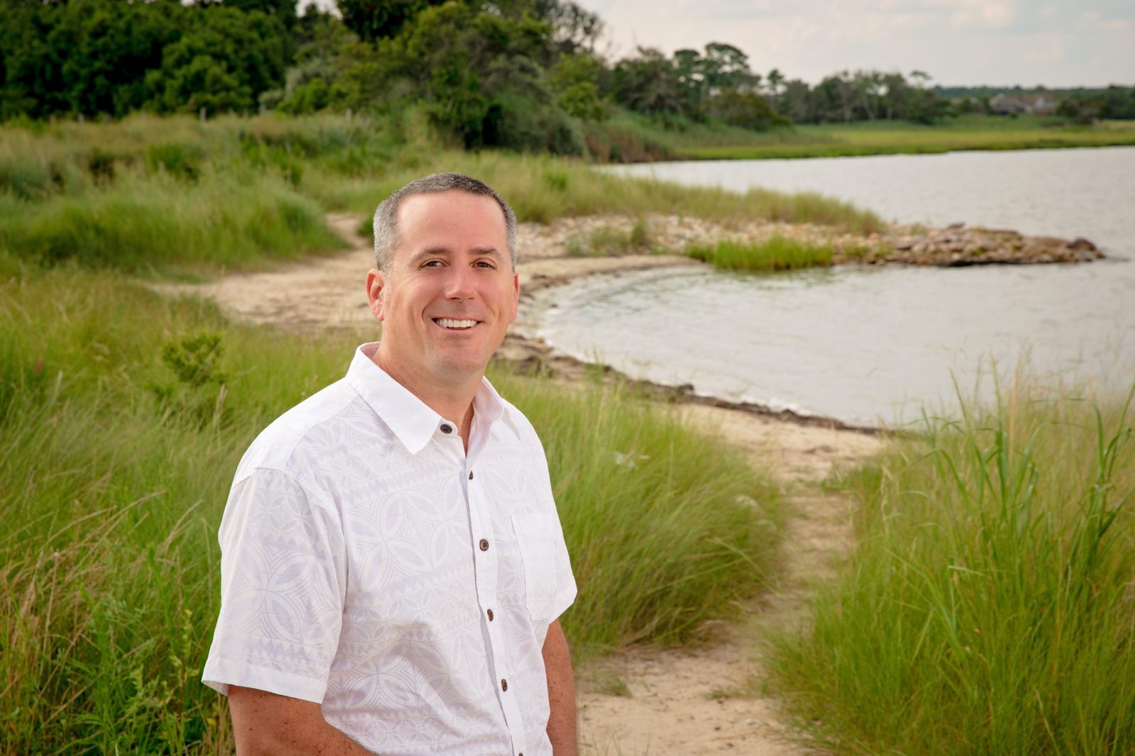 Brian Foley on a sandy path along the bay